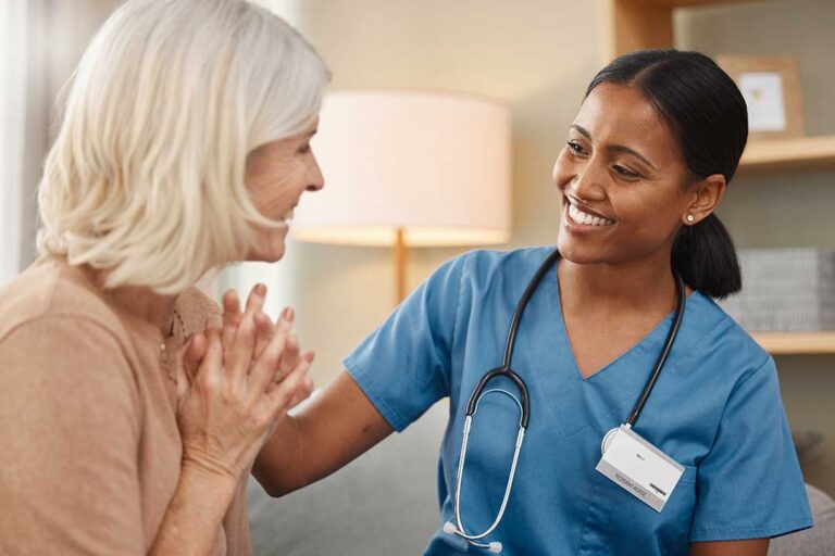 Older adult and family member reviewing a daily care checklist at a kitchen table
